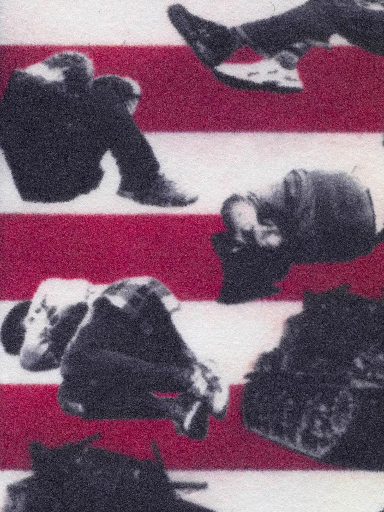 Assembly Line, 2025, by in vivo. Detail: people sitting and lying curled on the stripes beside a tank.