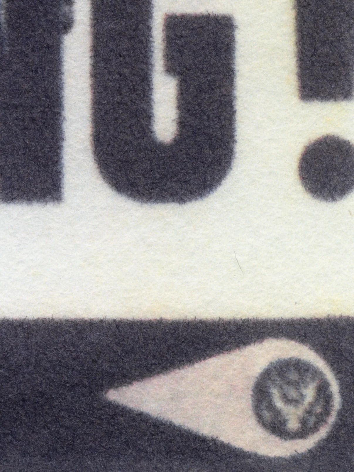 Assembly Line, 2025, by in vivo. Detail: the end of the slogan, an exclamation mark, and the in vivo eye mark holding a seal.