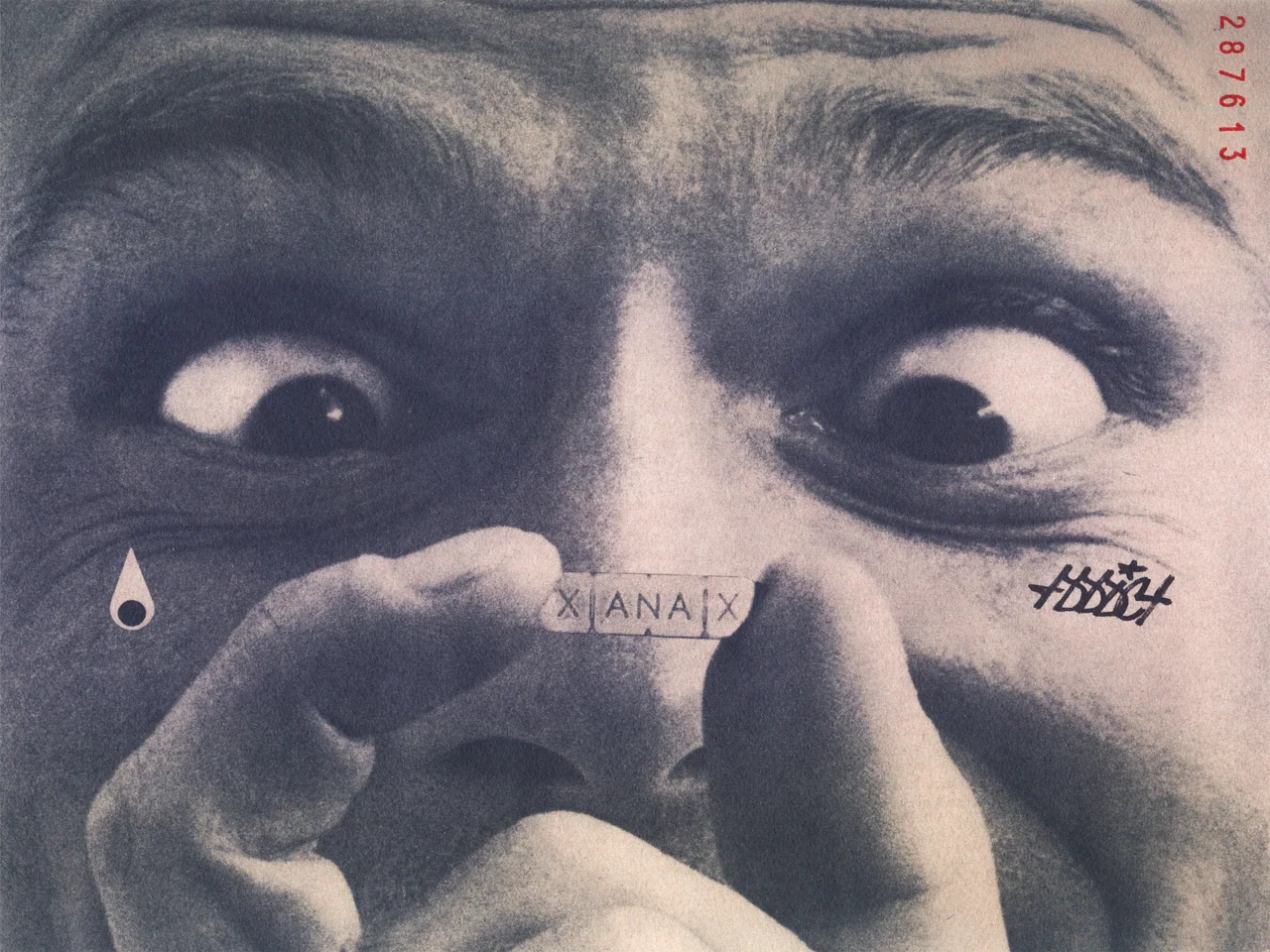 Ephemera, 2025, ink, acrylic paint pen and stamp on cotton, by in vivo. A wide eyed face, cross eyed, holding a Xanax bar on the bridge of the nose; a teardrop under one eye, a graffiti tag under the other, cypher 287613 at the edge.